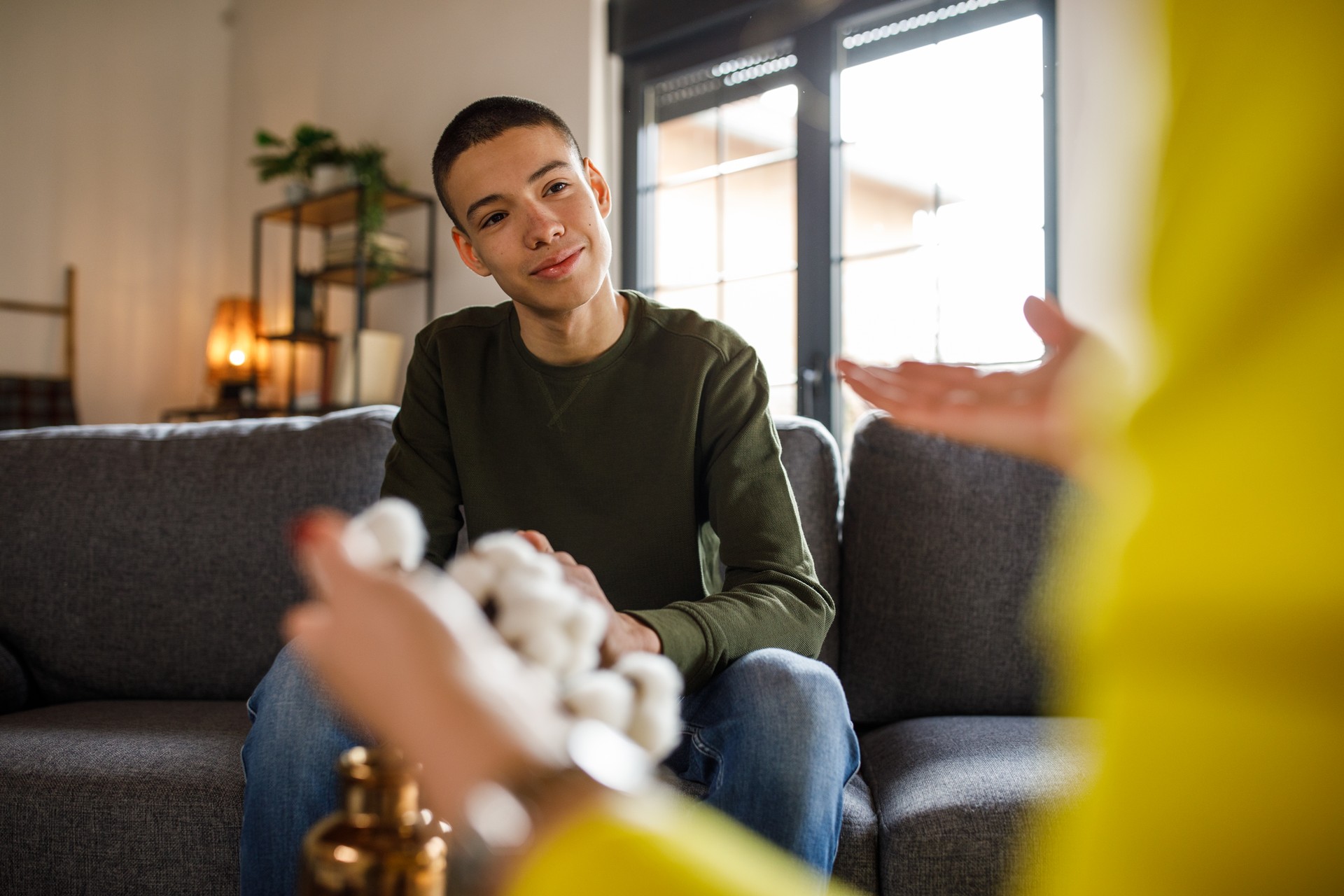 Insecure teenage boy having a sincere conversation with his reassuring mother